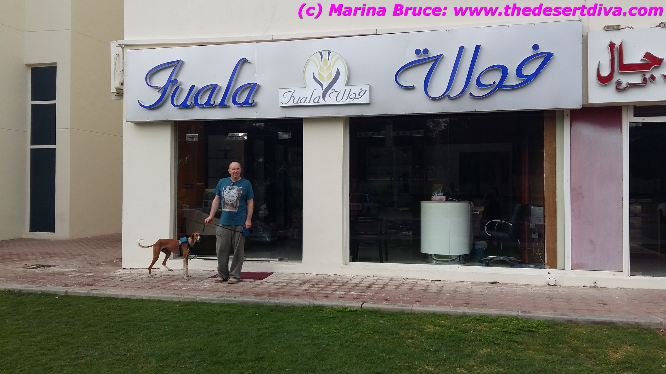 A man and his saluki pictured outside a shop