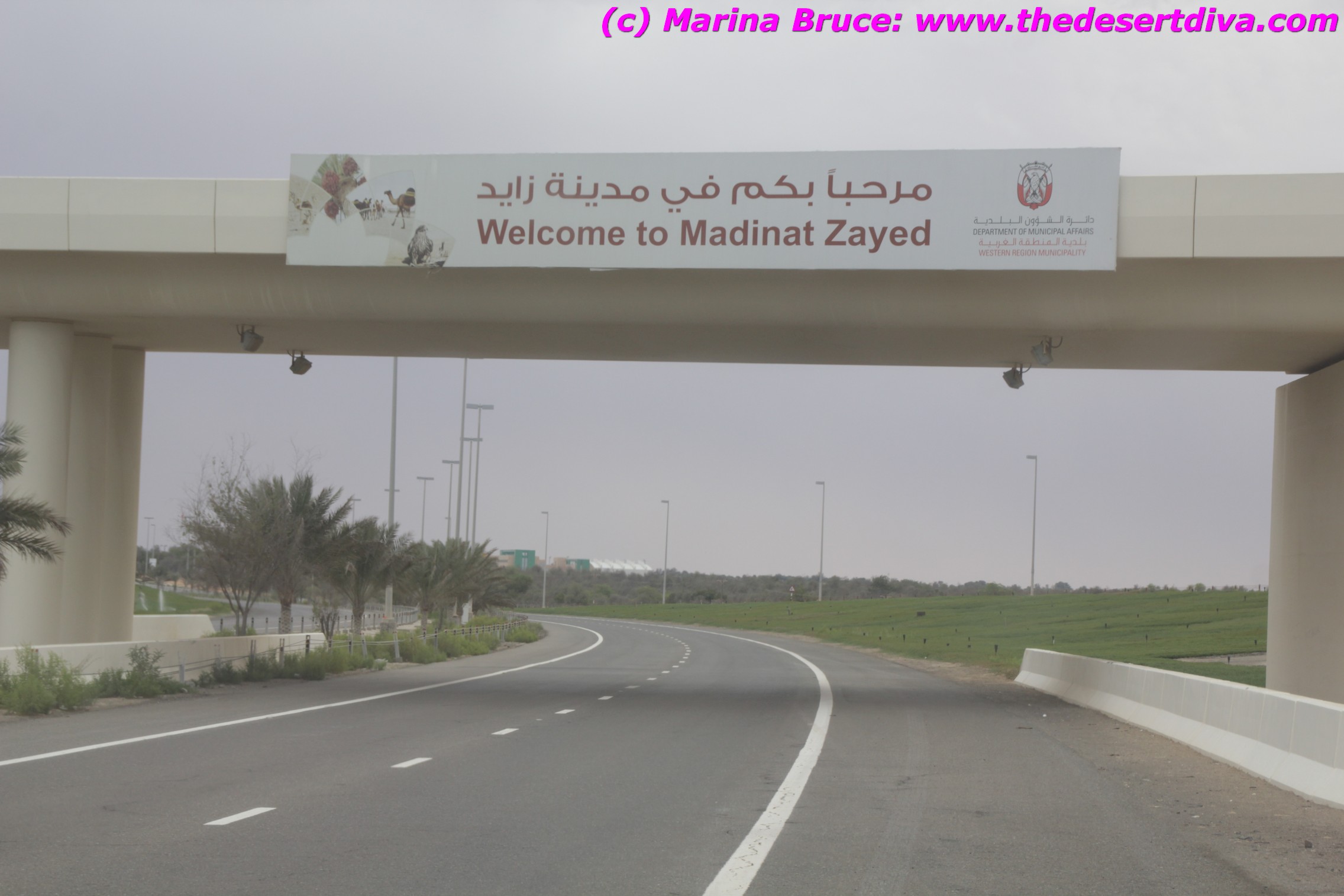 Sign on flyover welcoming visitors to Madinat Zayed