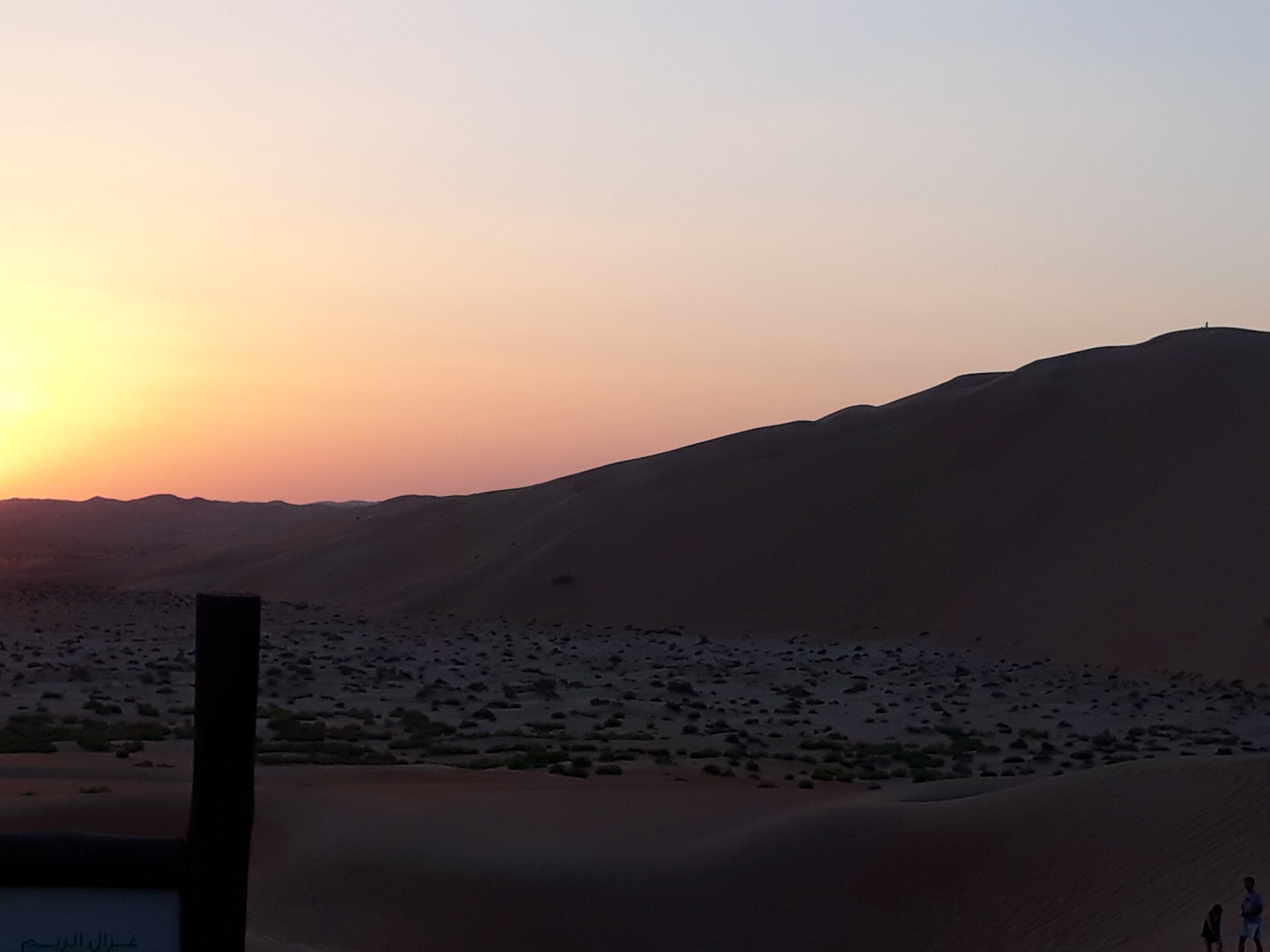 Looking out to a tall dune in the fading light from the Qasr Al Sarab